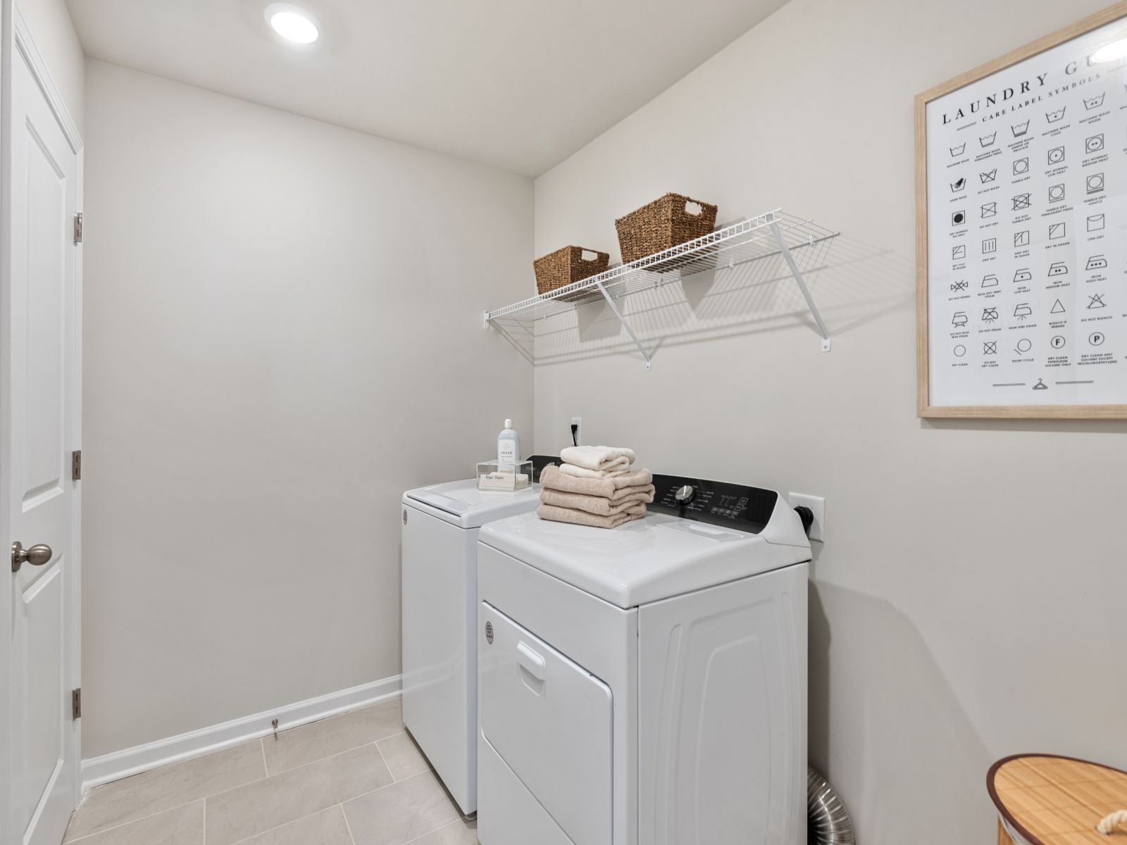 Laundry is a breeze with an abundance of storage for sorting and folding clothes.