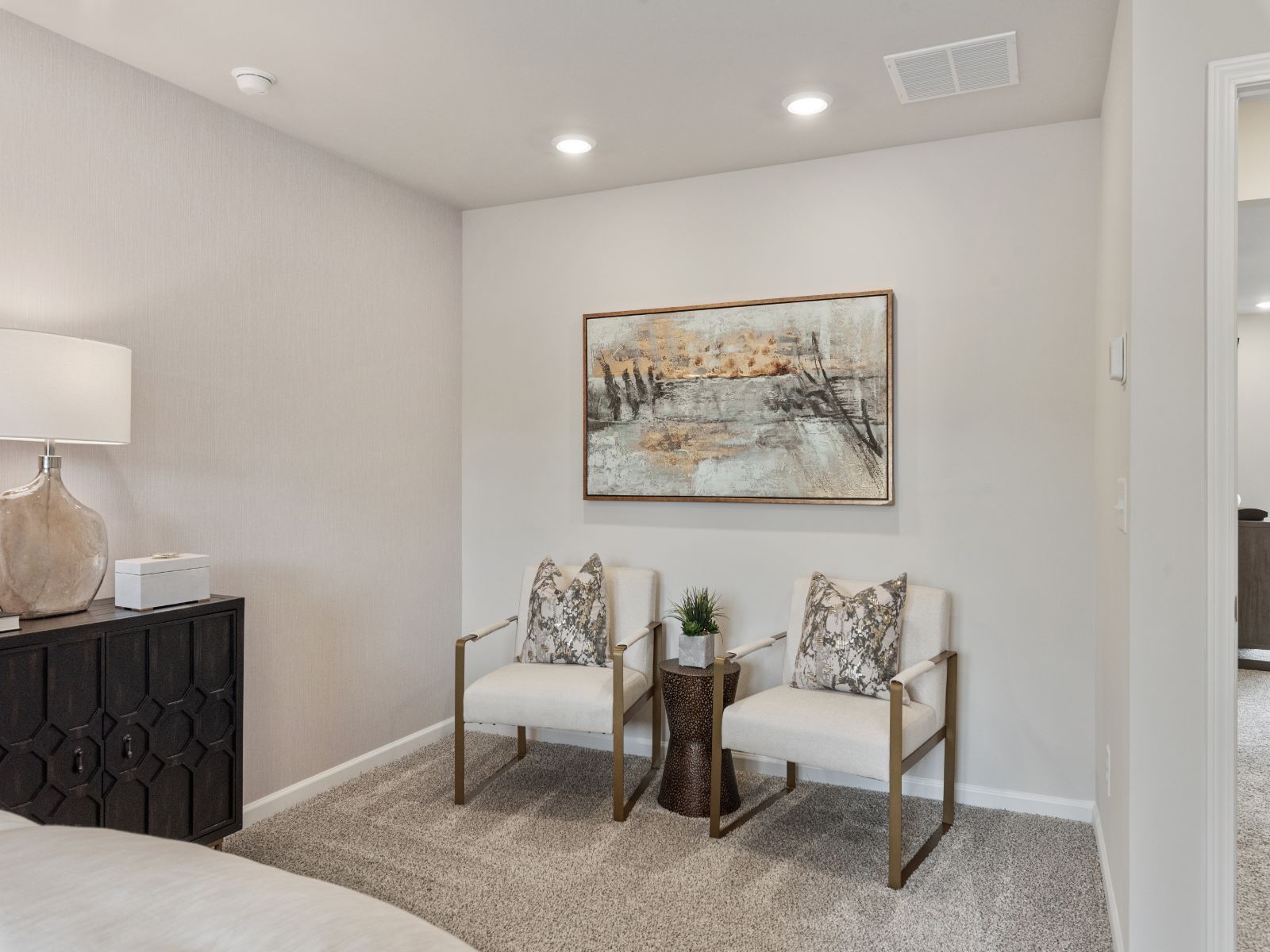 The spacious primary suite provides extra room for a seating or lounge area.