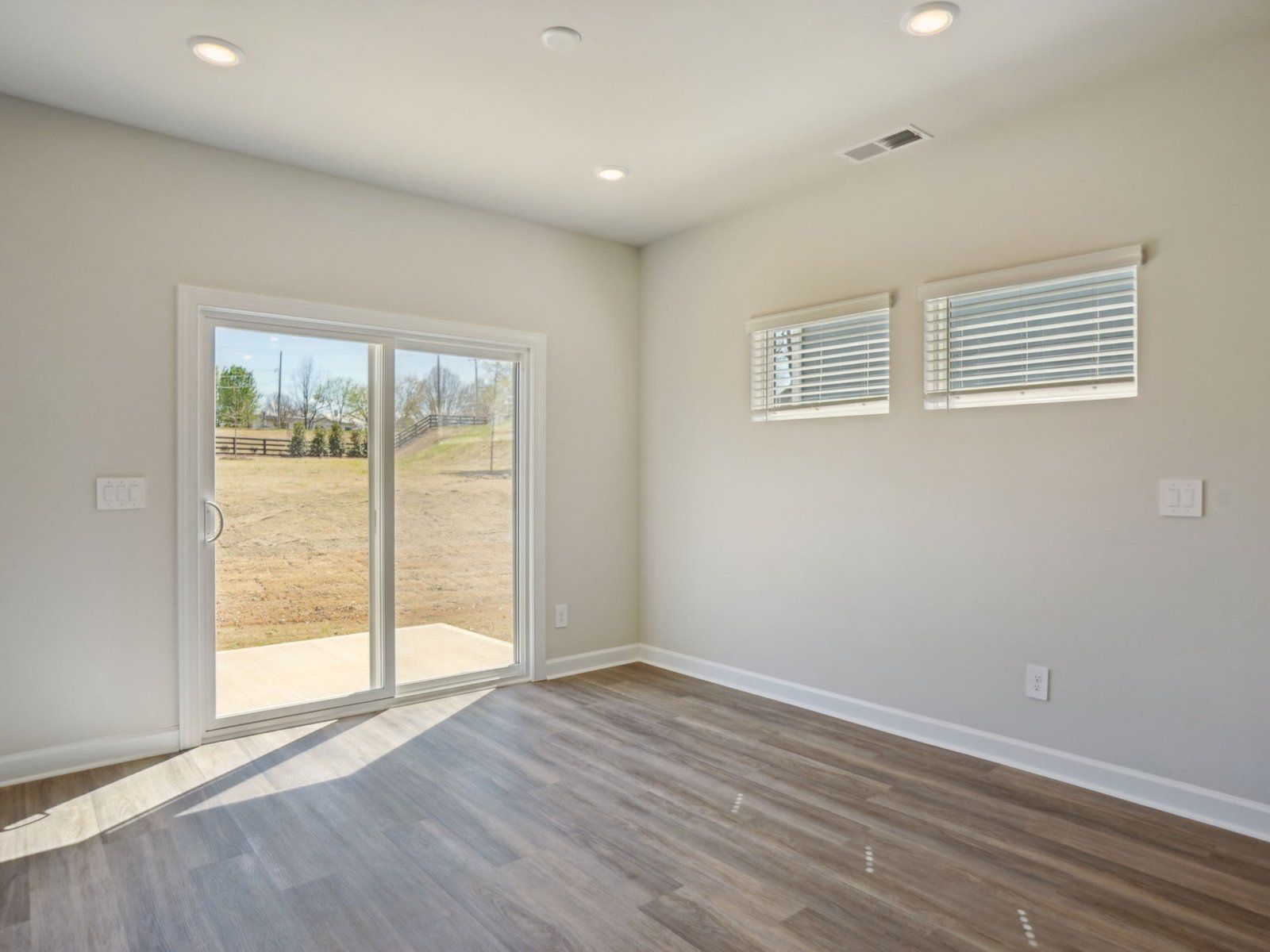 The great room offers an abundance of natural light and direct access to the outdoor patio.