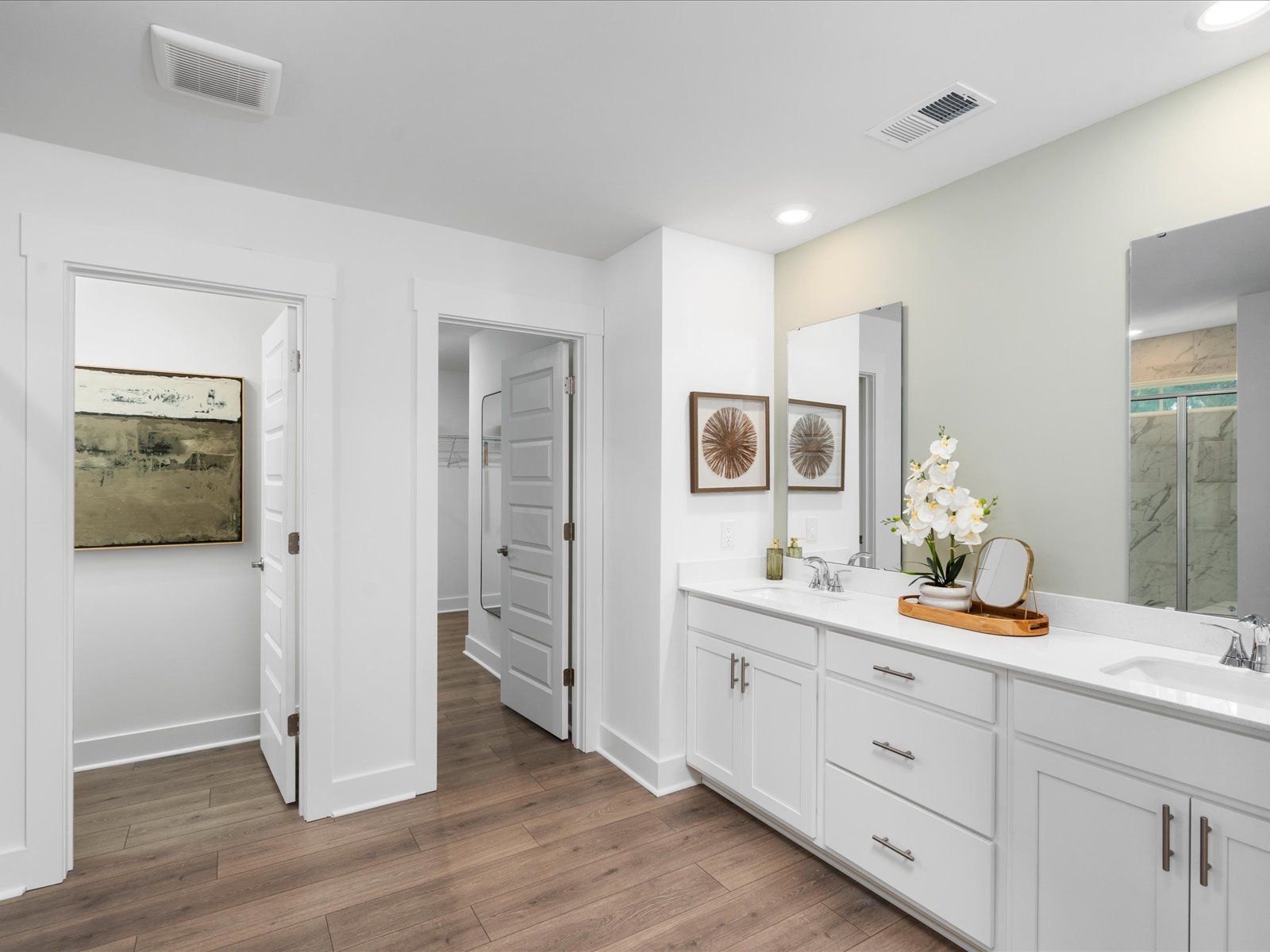 The primary ensuite boasts duel sinks, tile shower and large walk-in closet.