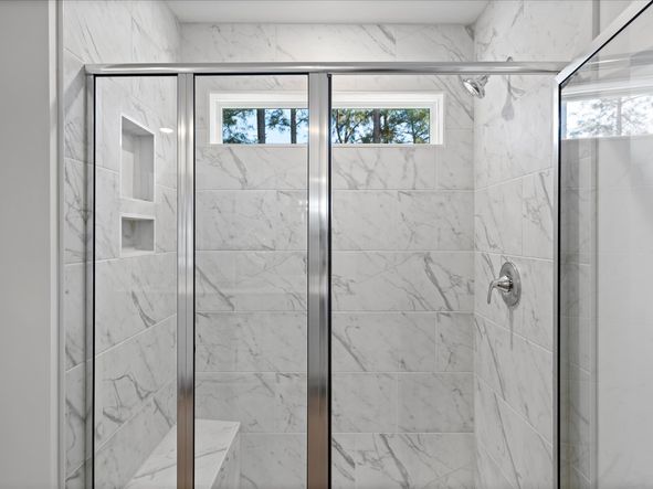 The primary ensuite boasts duel sinks, tile shower and large walk-in closet.