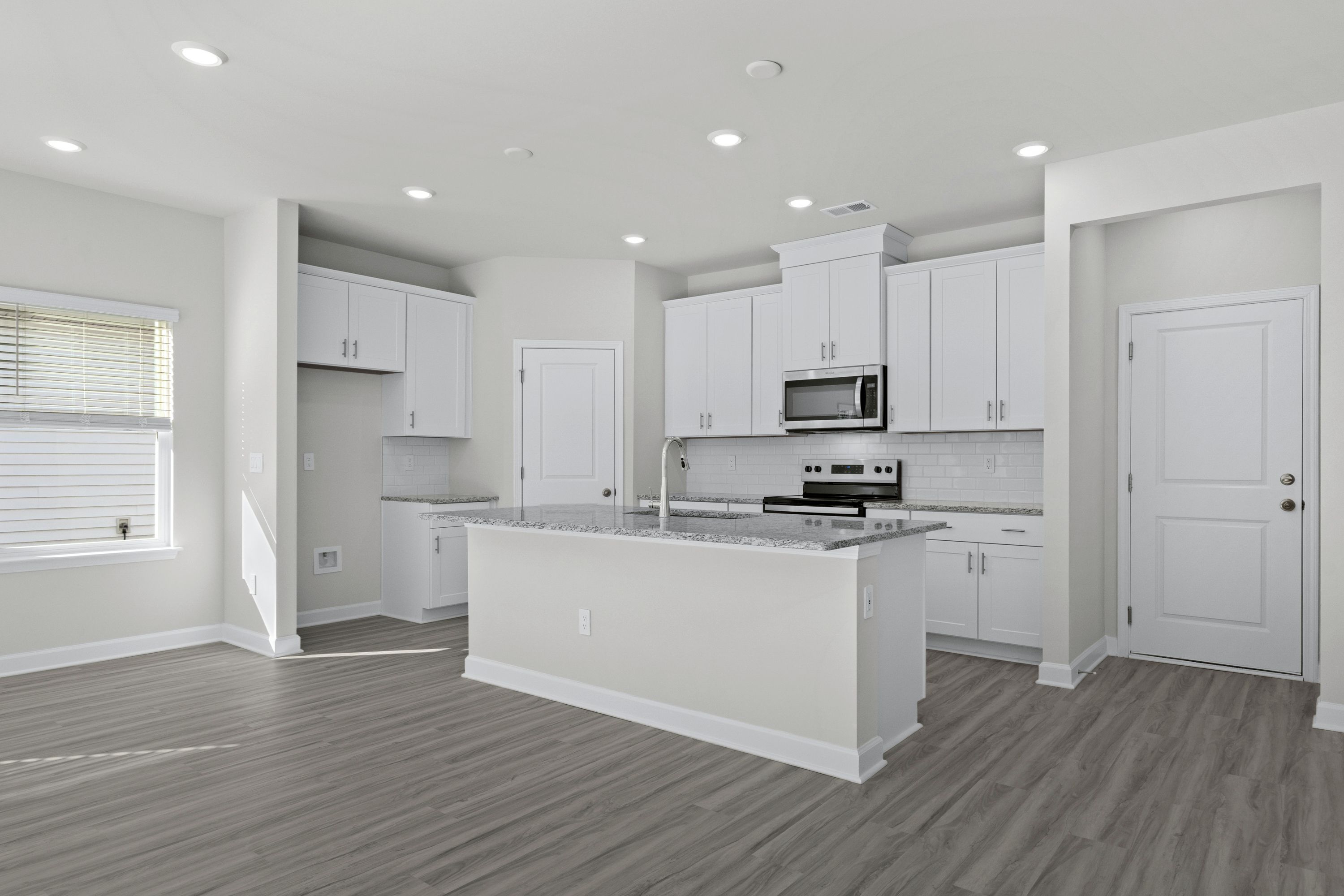 The well-appointed kitchen features a large island to make meal prep a breeze.