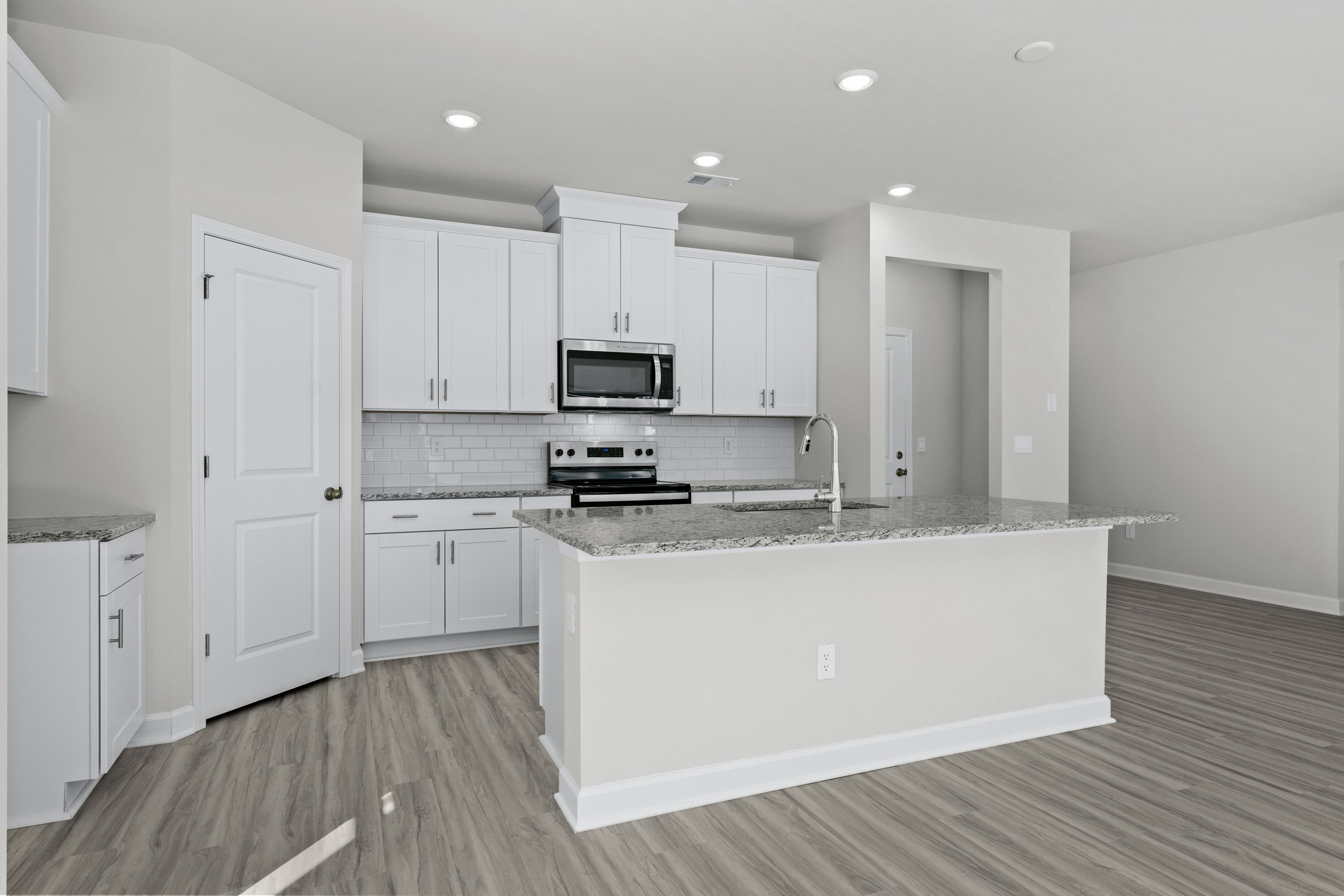 The well-appointed kitchen features a large island to make meal prep a breeze.