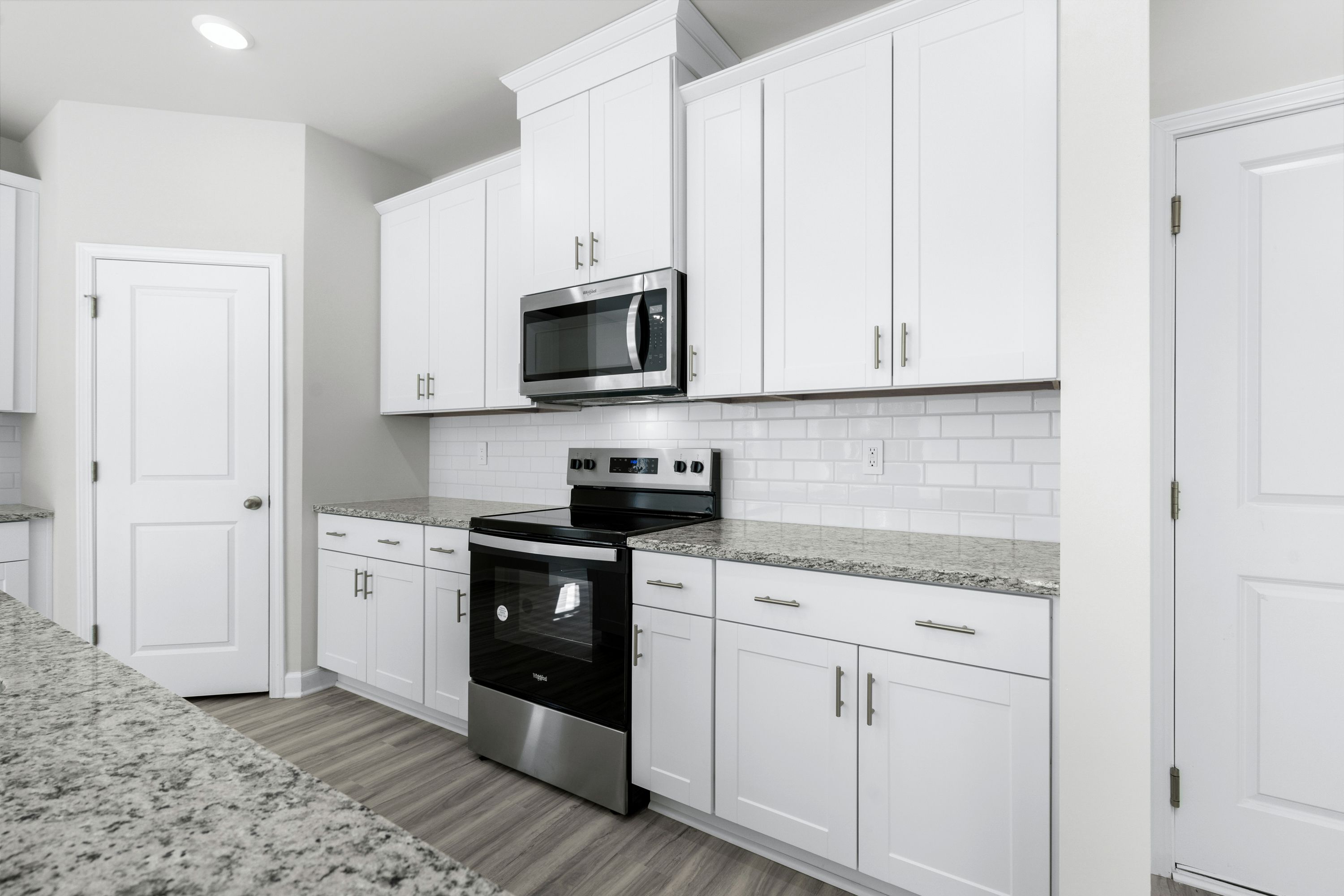 The large kitchen features stunning finishes and corner pantry.