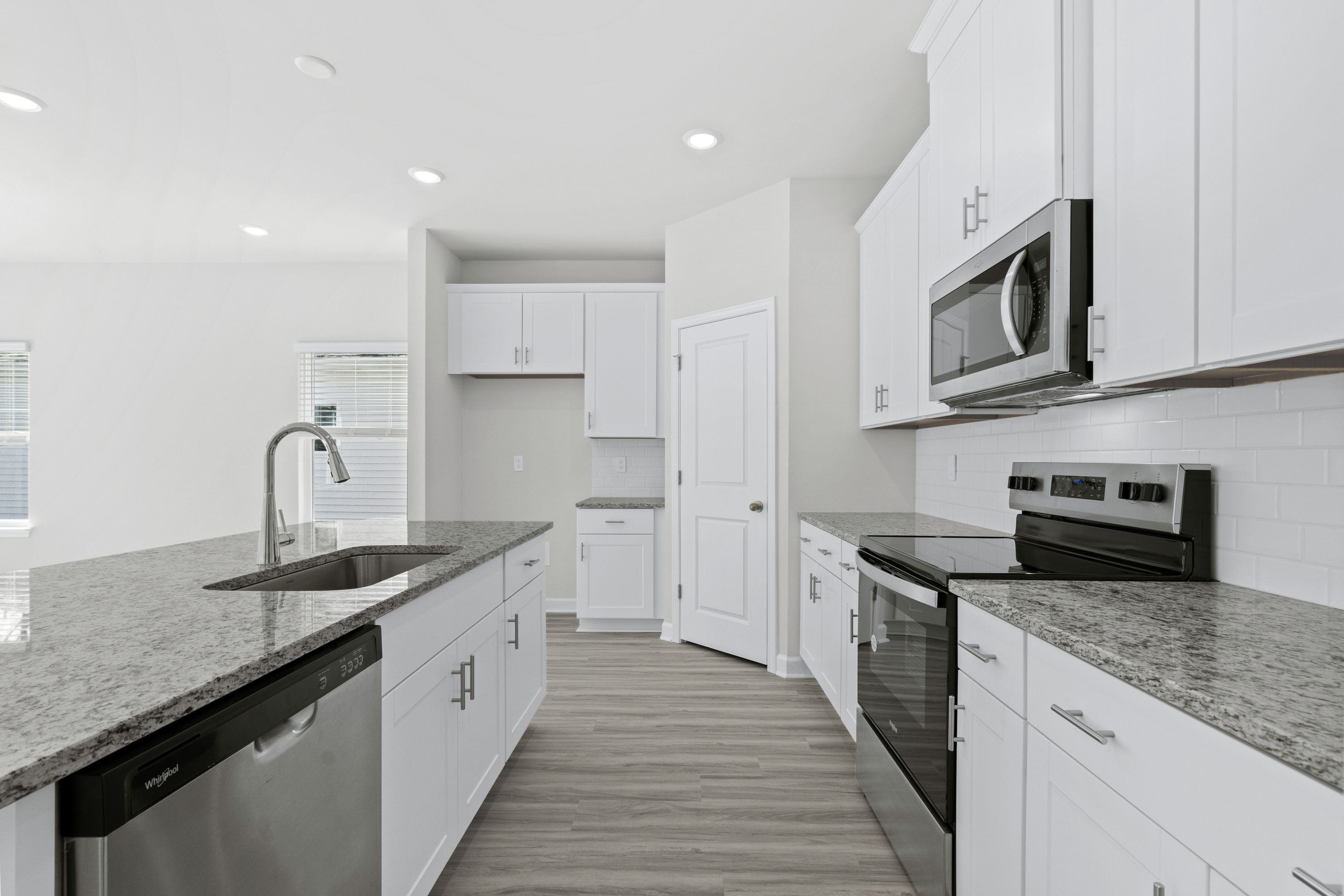 The large kitchen features stunning finishes and corner pantry.