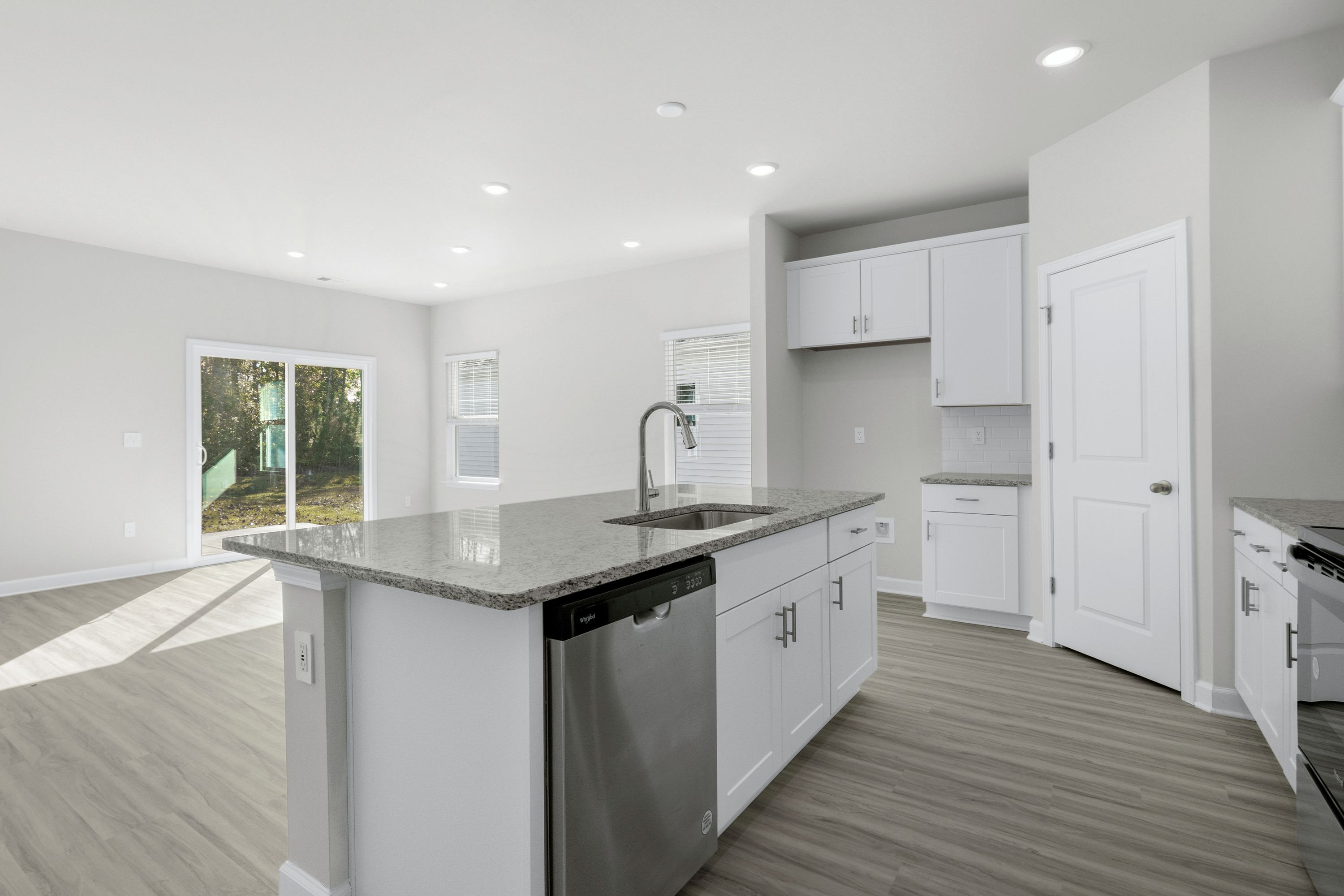 The large kitchen features stunning finishes and corner pantry.