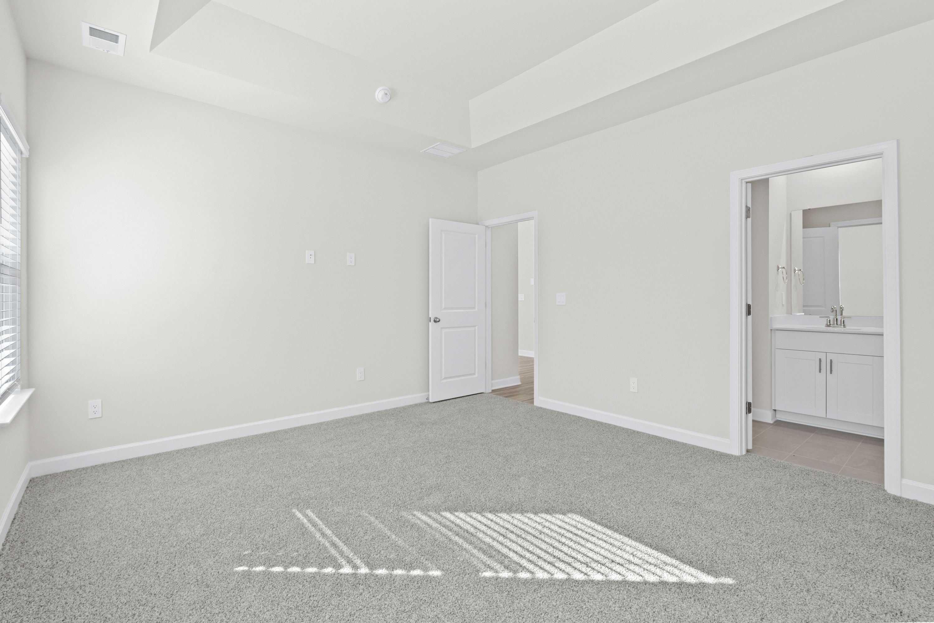 A private primary bedroom is accentuated with a tray ceiling.
