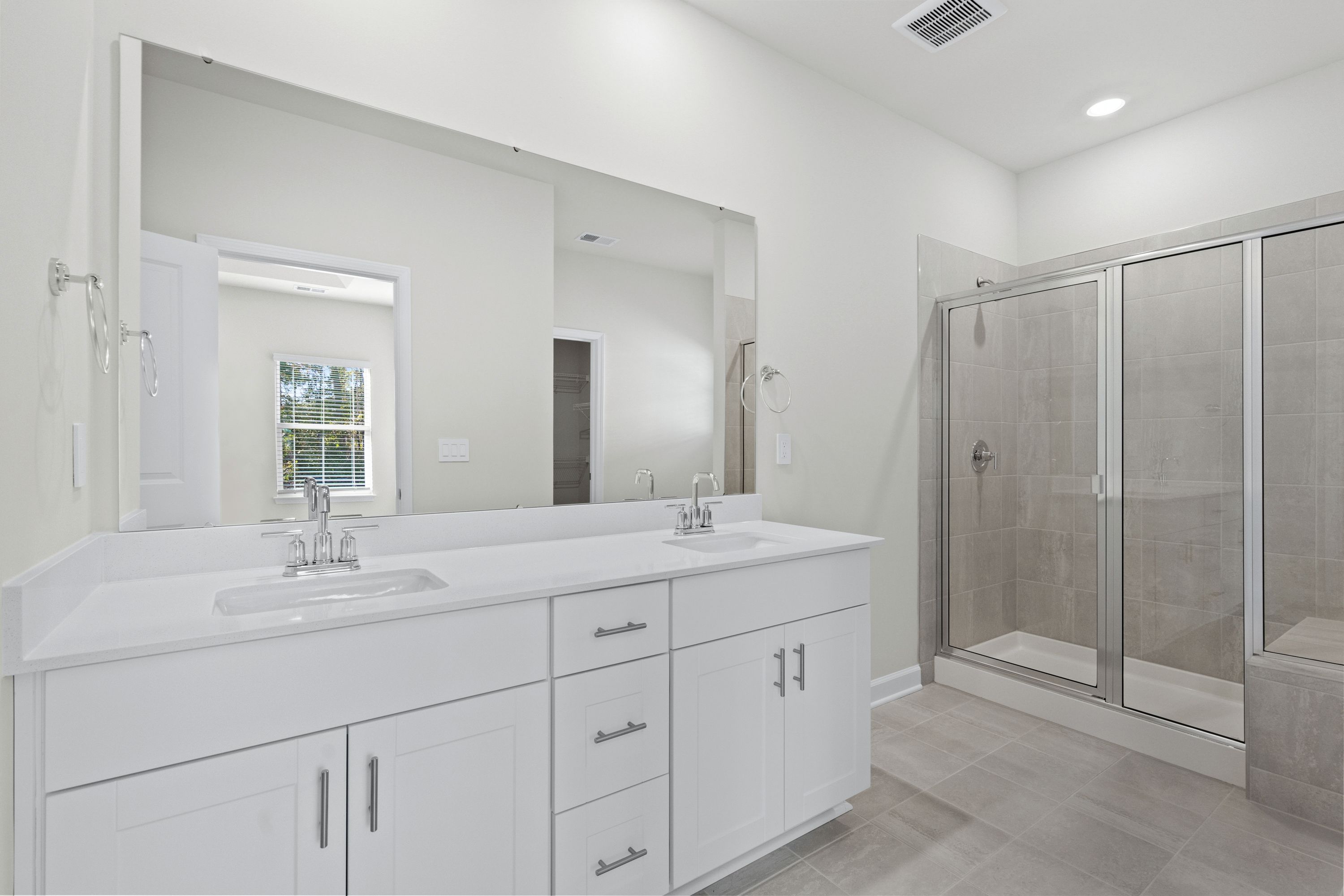 The primary ensuite boasts duel sinks, tile shower and large walk-in closet.