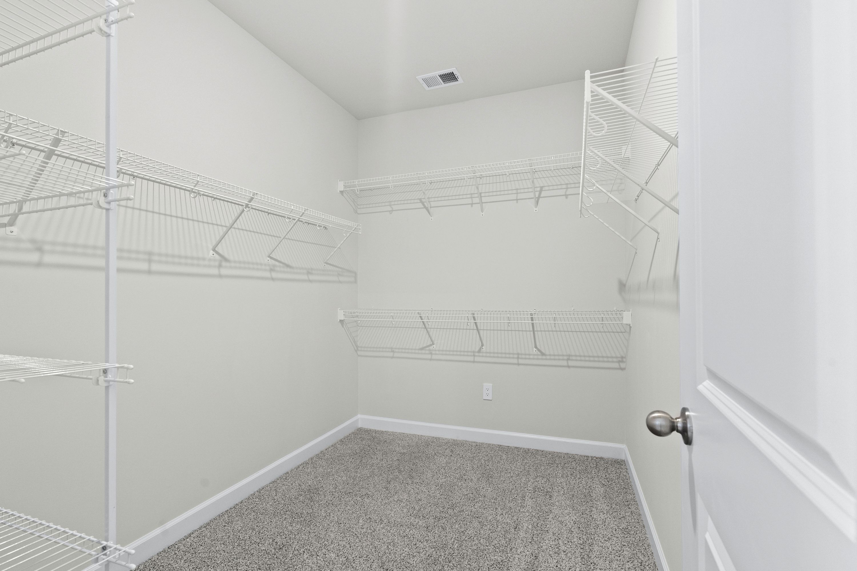 The walk-in closet off of the primary bathroom offers an abundance of space.