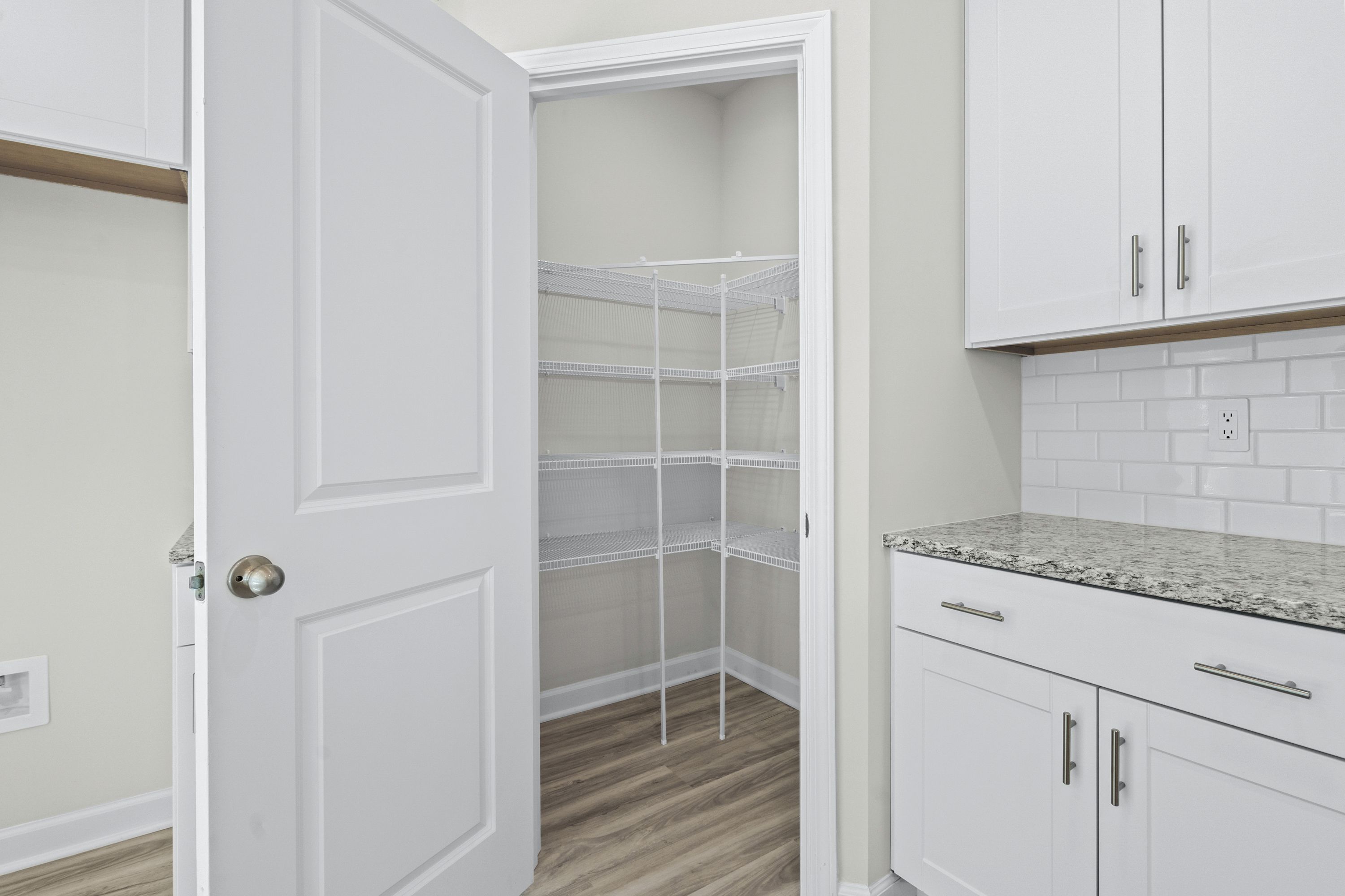 The large kitchen features stunning finishes and corner pantry.