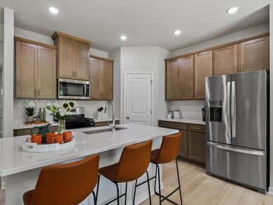 The kitchen provides ample prep and storage space with a sizeable island overlooking the great room.