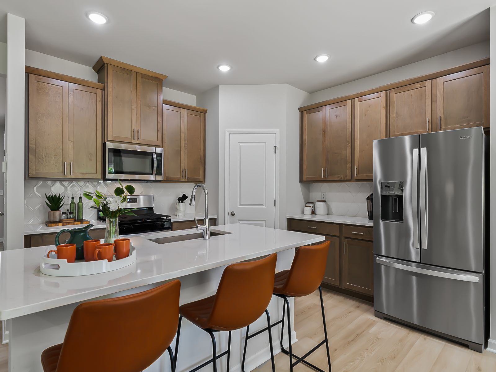The kitchen provides ample prep and storage space with a sizeable island overlooking the great room.