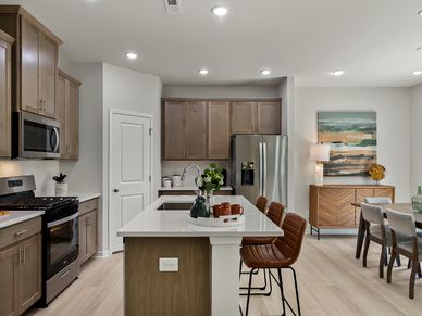 The kitchen provides ample prep and storage space with a sizeable island overlooking the great room.