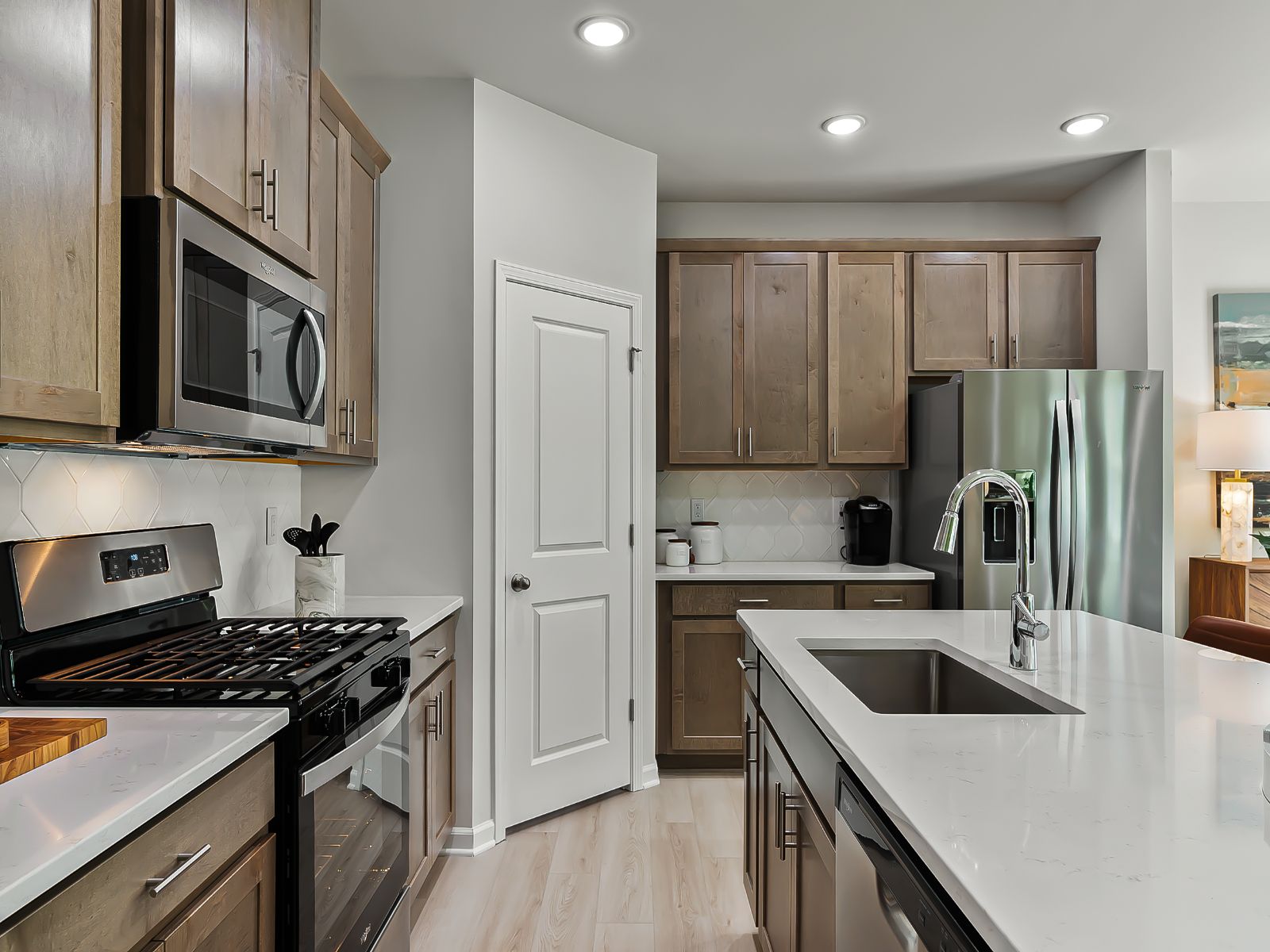 The kitchen provides ample prep and storage space with a sizeable island overlooking the great room.