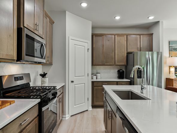 The kitchen provides ample prep and storage space with a sizeable island overlooking the great room.