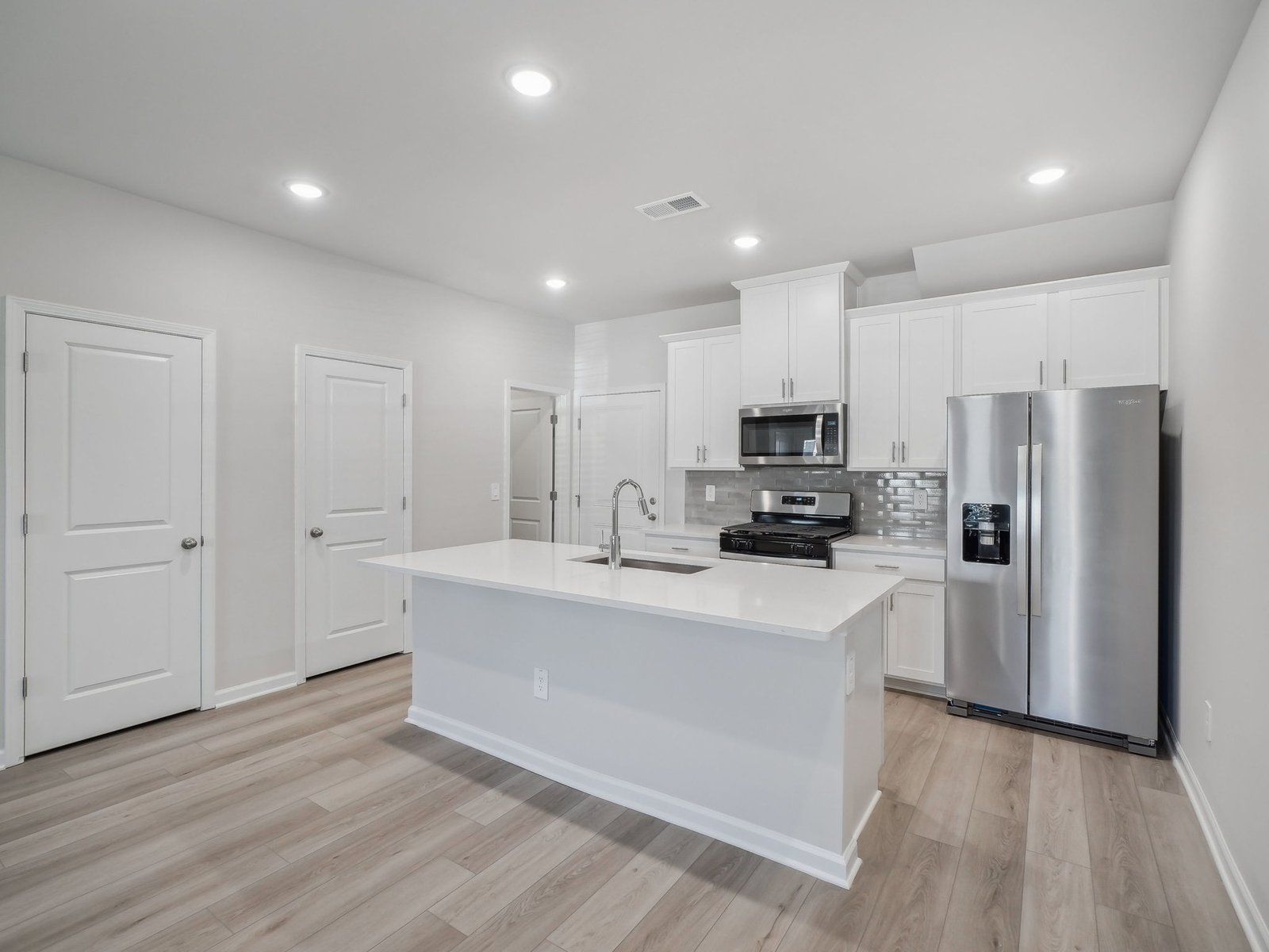 A sizeable kitchen island overlooks the sprawling great room.
