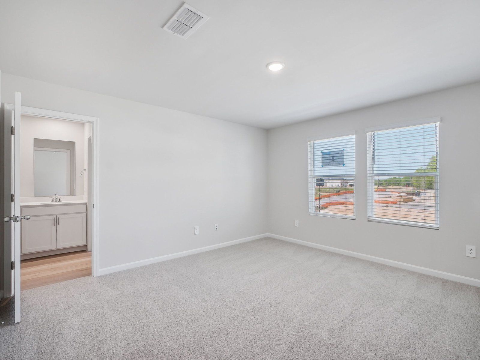 The luxurious primary suite features an ensuite bath with dual sinks and a walk-in closet.