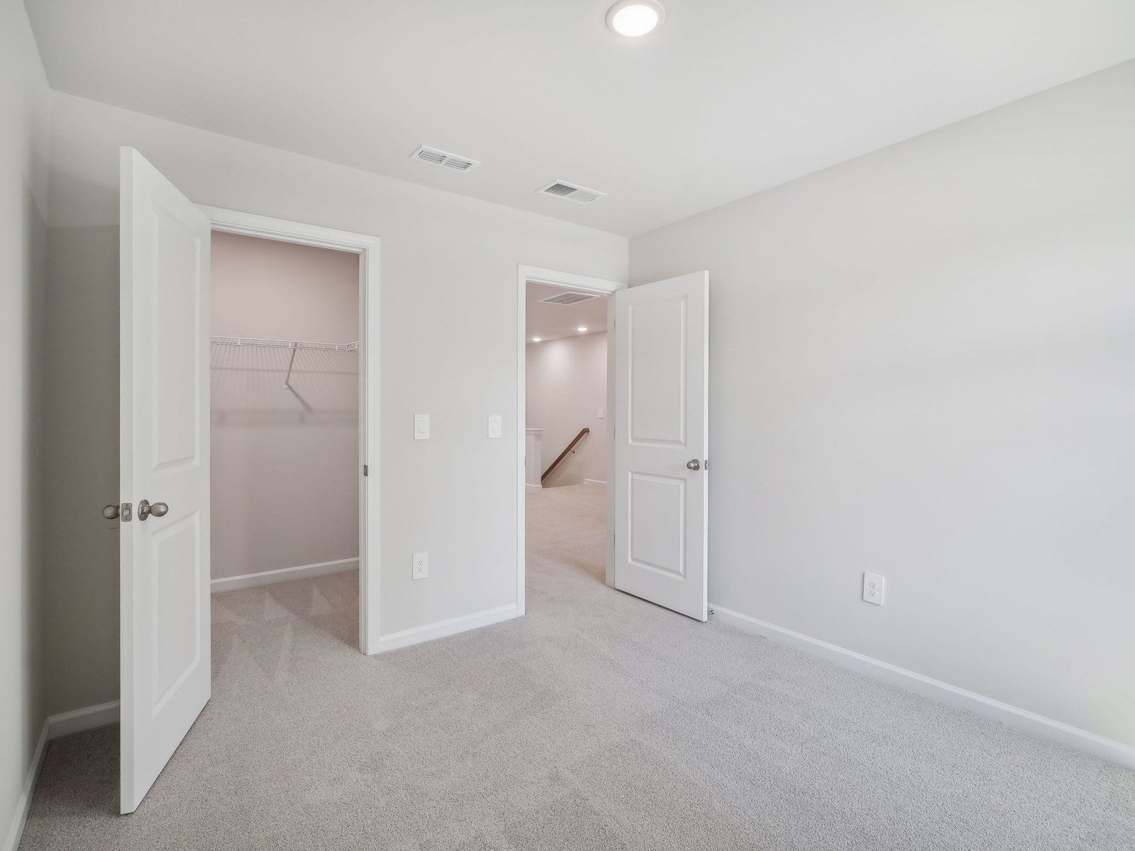 Two secondary bedrooms are ideally situated away from the primary suite.