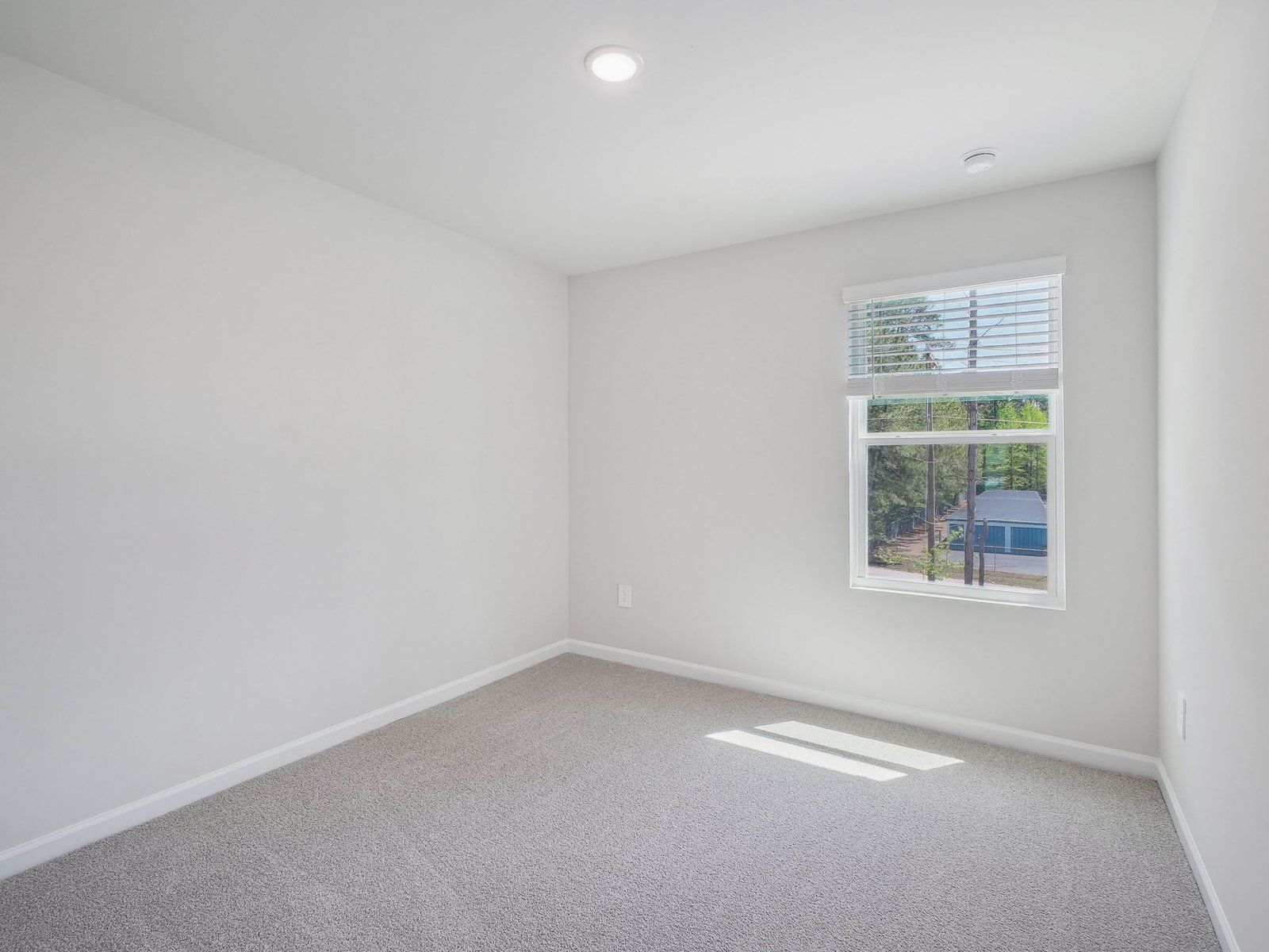 Two secondary bedrooms are ideally situated away from the primary suite.