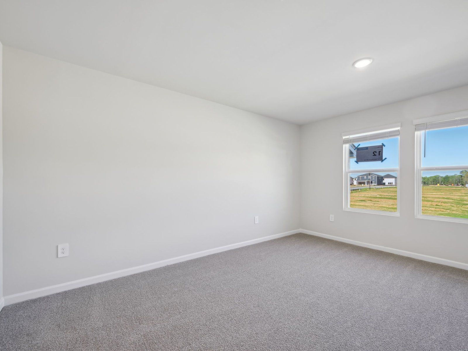 Relax in the spacious primary suite featuring an ensuite bath with dual sinks and a walk-in closet.
