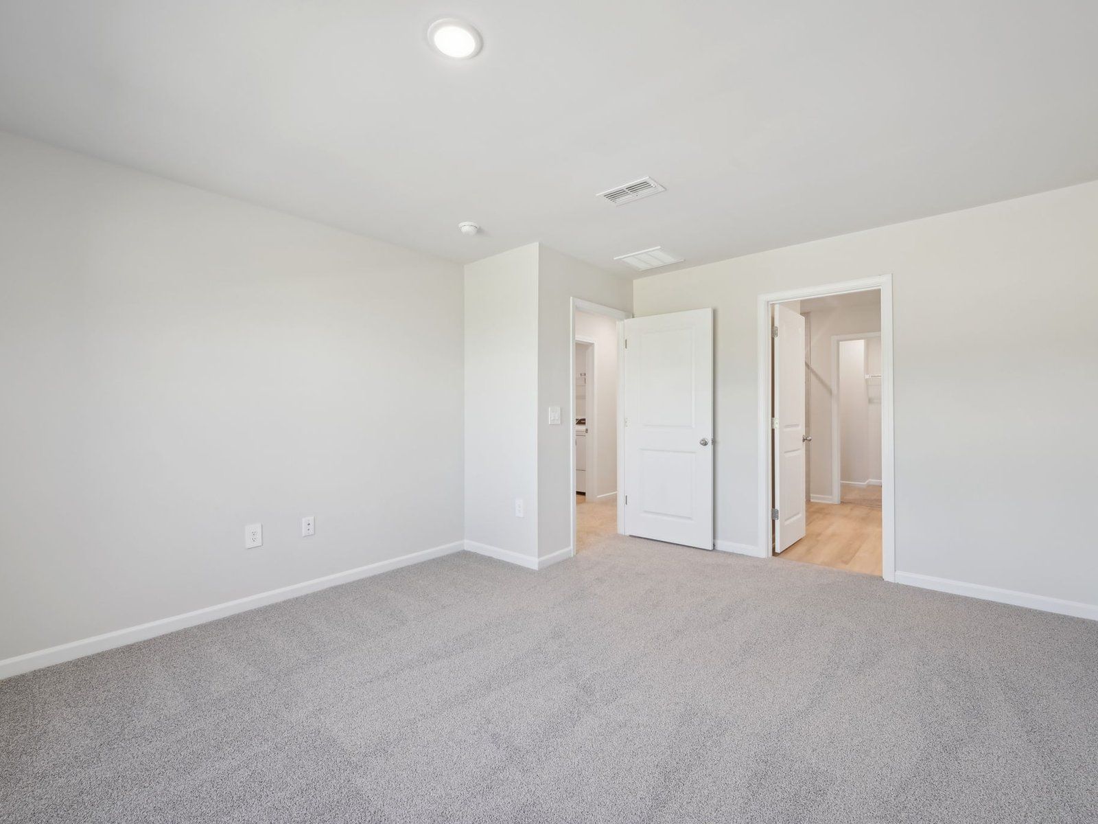 Relax in the spacious primary suite featuring an ensuite bath with dual sinks and a walk-in closet.