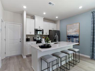 A large kitchen island overlooks the sprawling great room, perfect for entertaining.