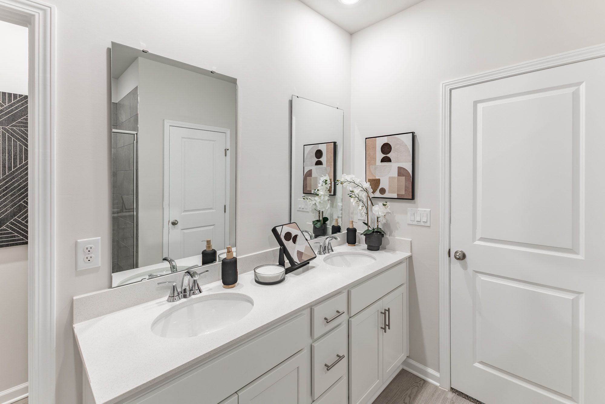The primary bathroom features dual-vanity sinks.