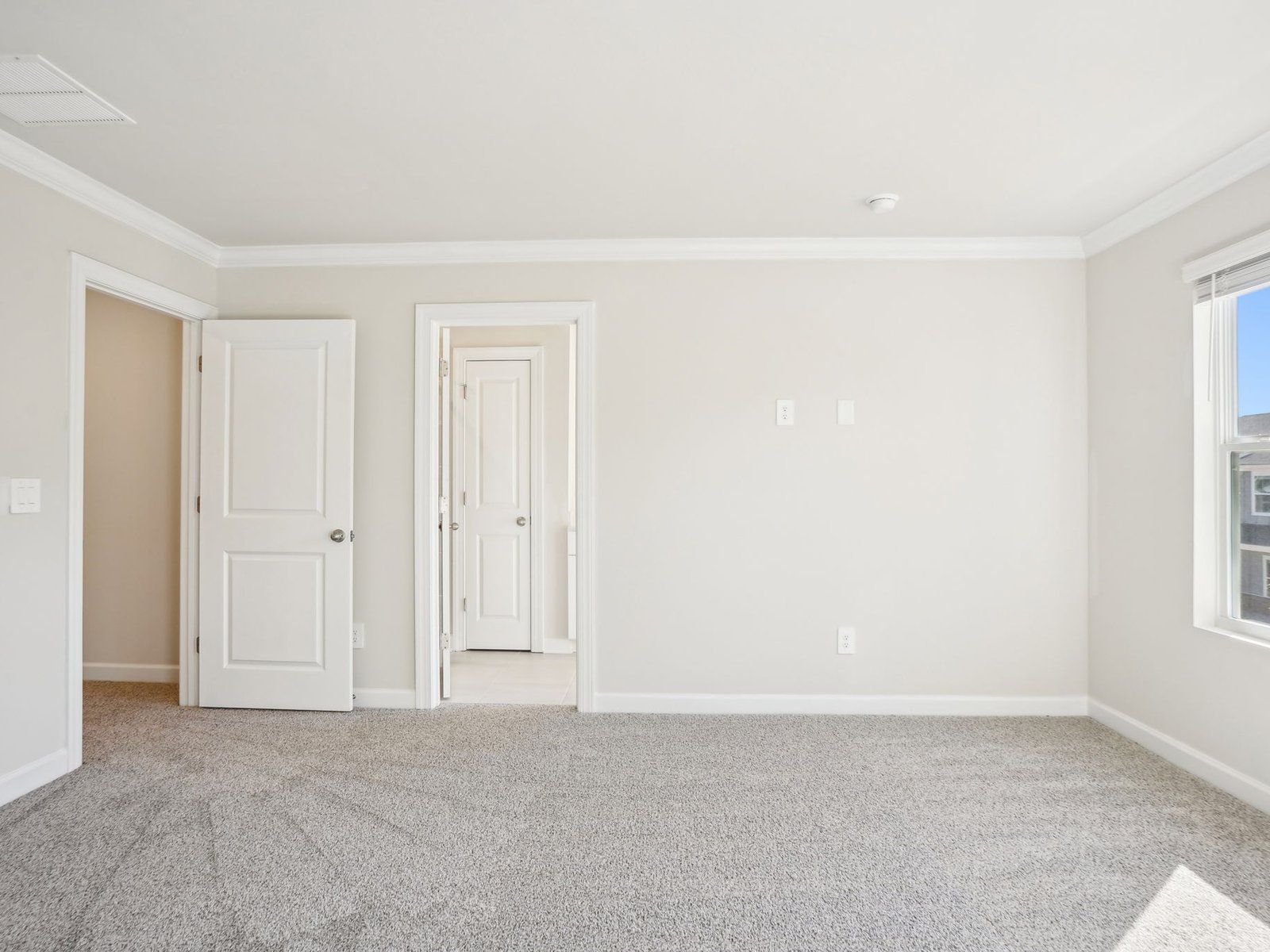 The primary bedroom connects conveniently to a private ensuite.