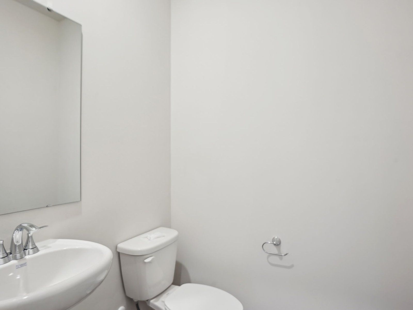 The half bathroom is conveniently located on the first floor for guests and visitors.