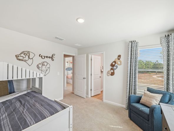 Two secondary bedrooms share a connected bathroom with dual sinks.