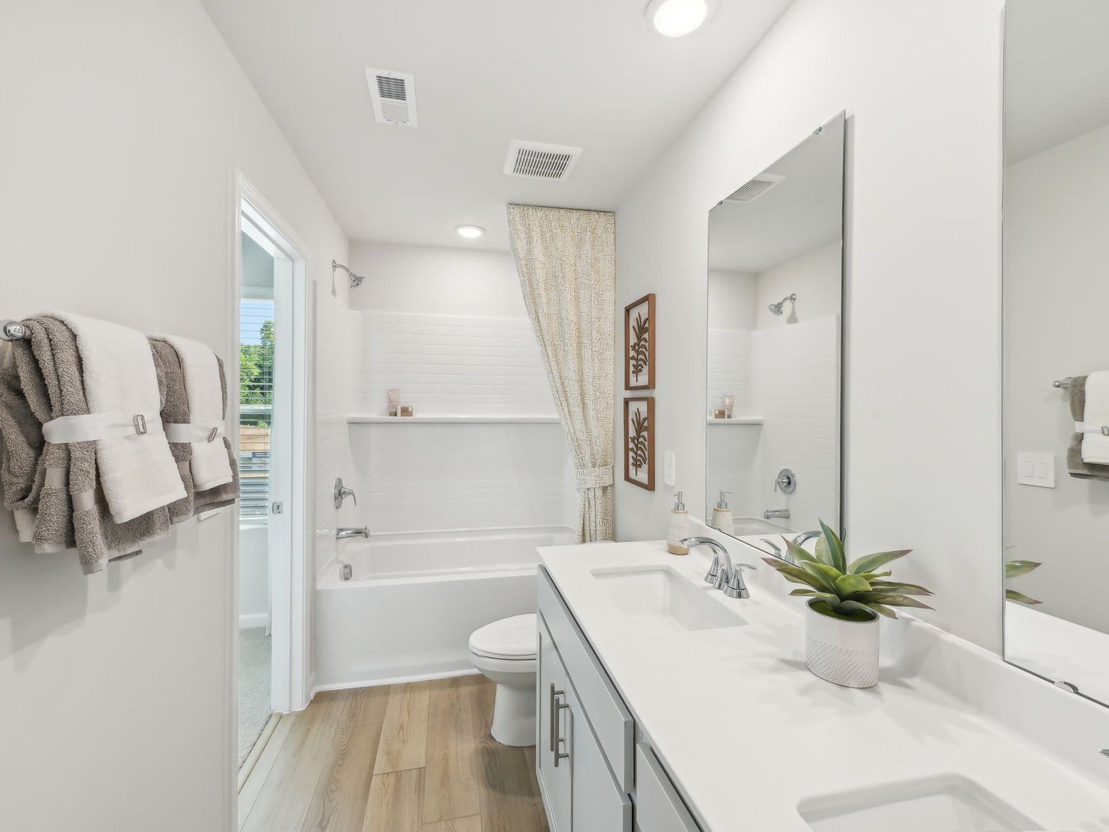Two secondary bedrooms share a connected bathroom with dual sinks.