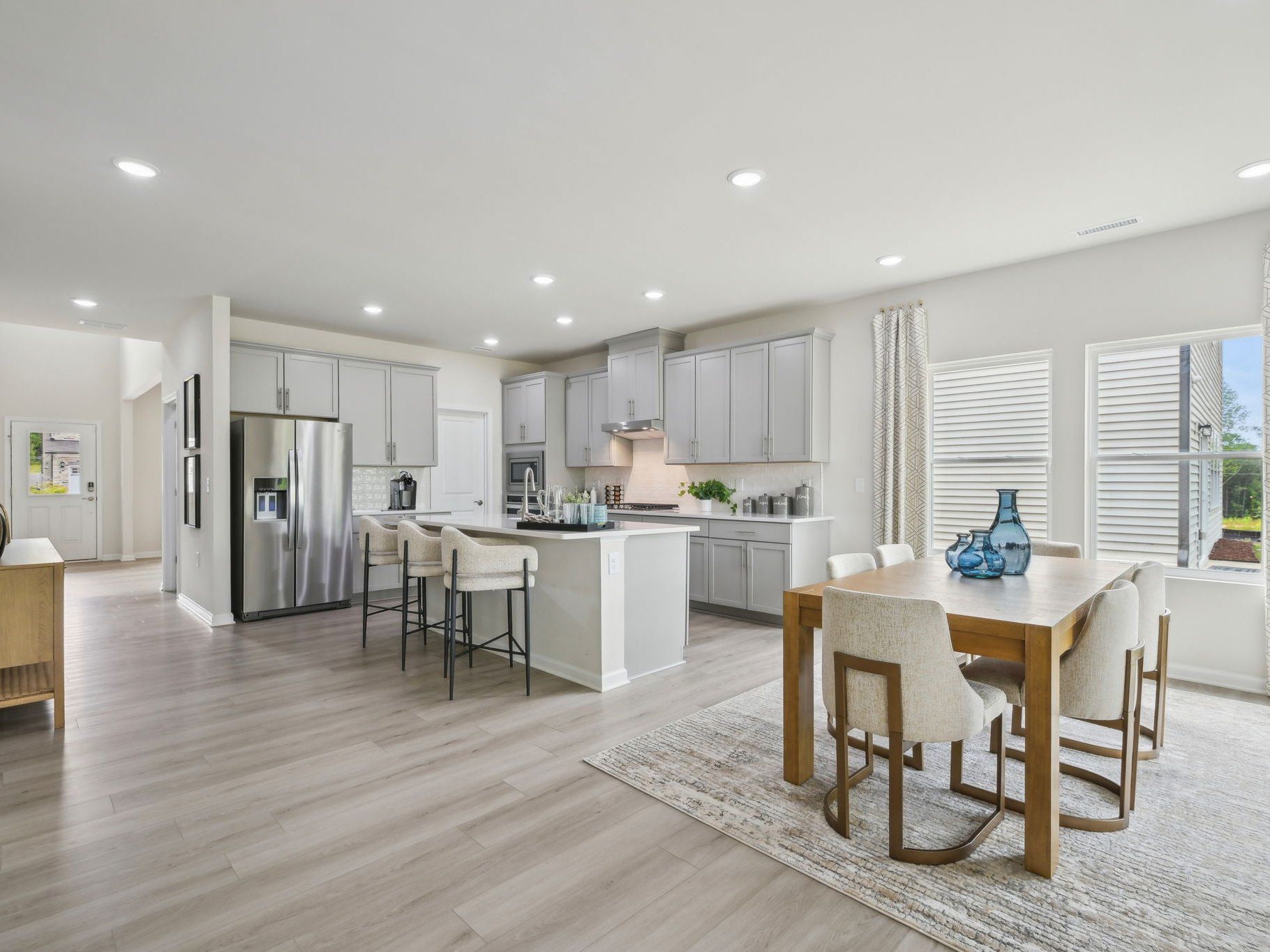 An abundance of natural light floods the living, dining and kitchen areas.
