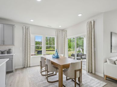 An abundance of natural light floods the living, dining and kitchen areas.