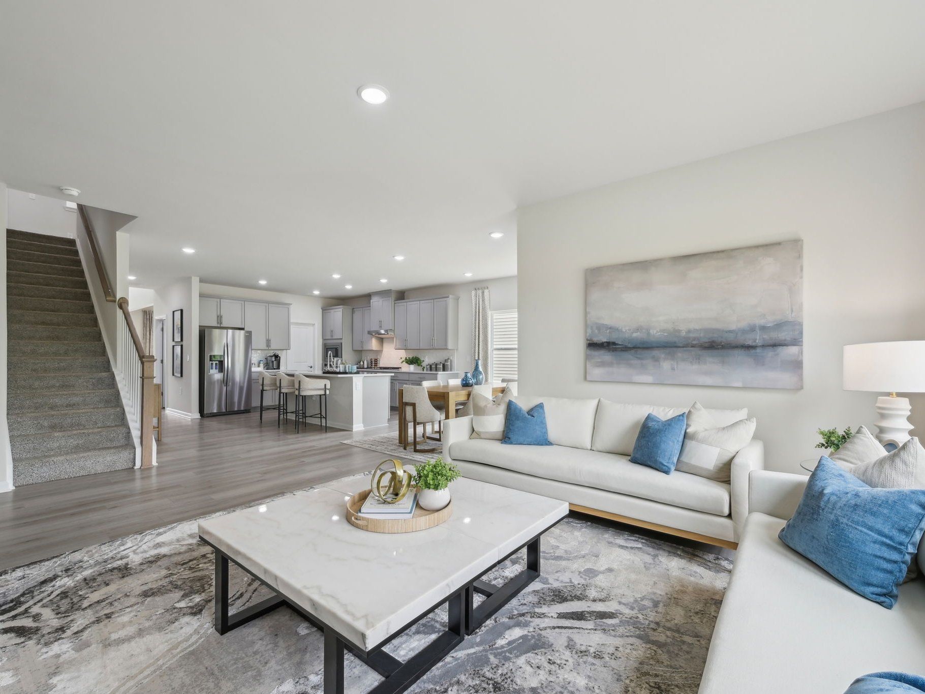 An abundance of natural light floods the living, dining and kitchen areas.