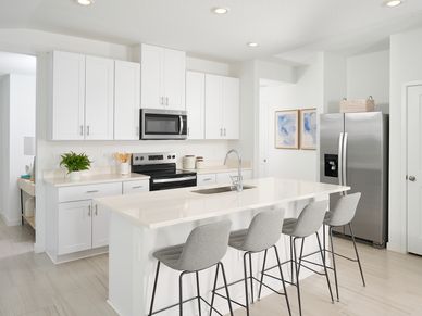 The Acadia floorplan kitchen modeled at Flagler Village.