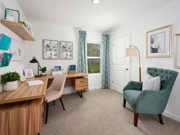 The Acadia floorplan secondary bedroom modeled at Flagler Village.