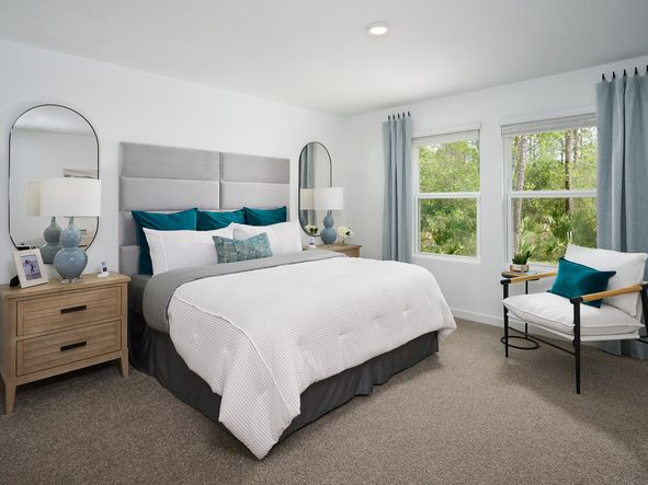 The Acadia floorplan primary bedroom modeled at Flagler Village.