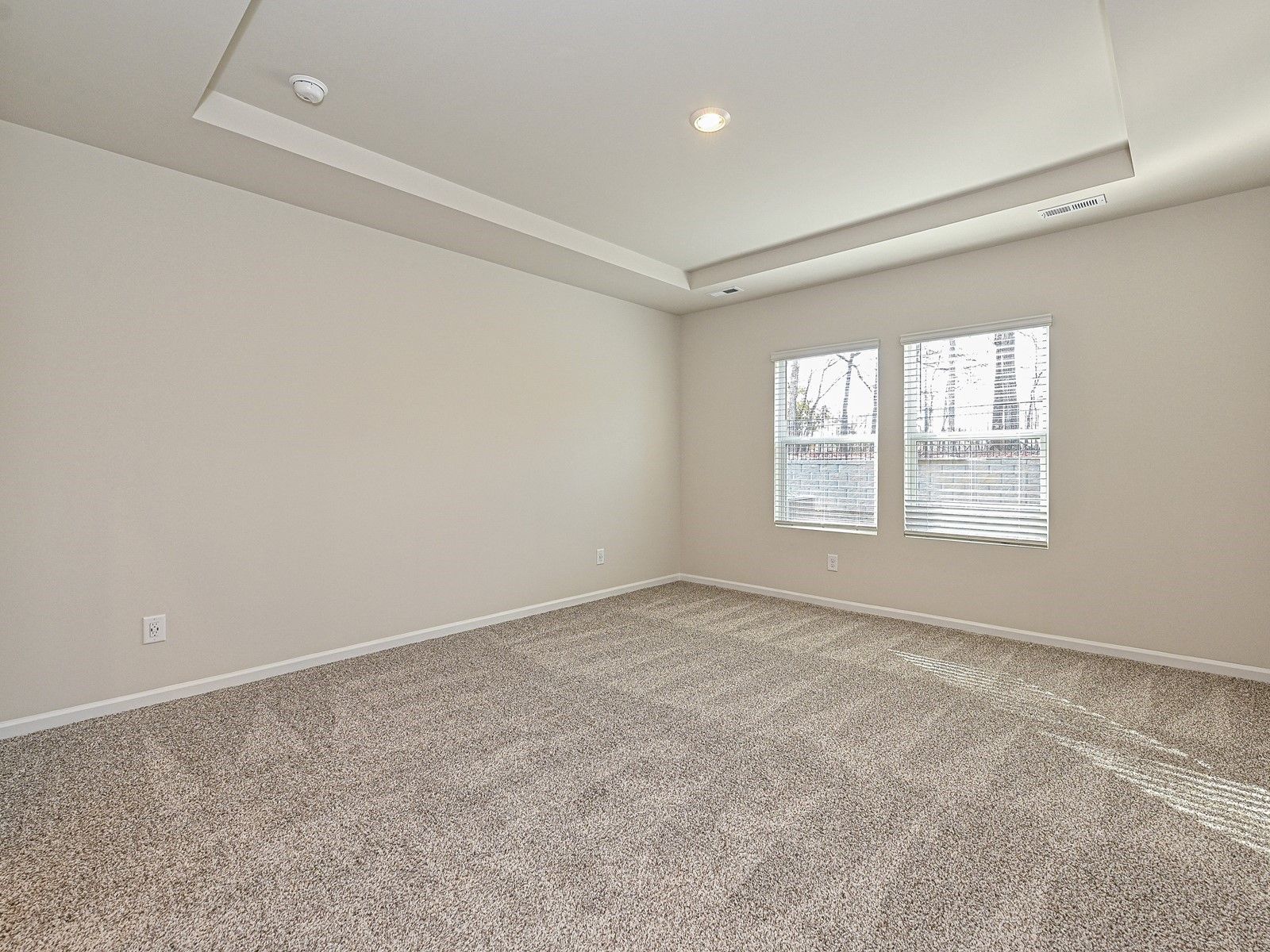 The spacious primary bedroom is the best spot to relax and unwind after a long day.