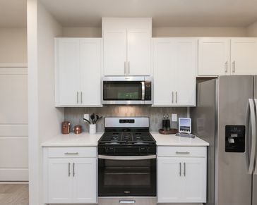 Stylish cabinets and a sleek stovetop add charm and function to your kitchen.