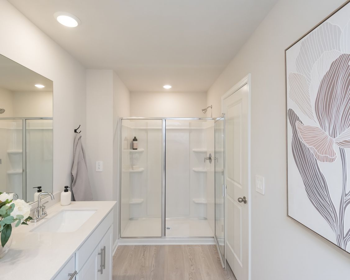 Take a warm shower in the primary bath's walk-in shower, the perfect way to unwind.