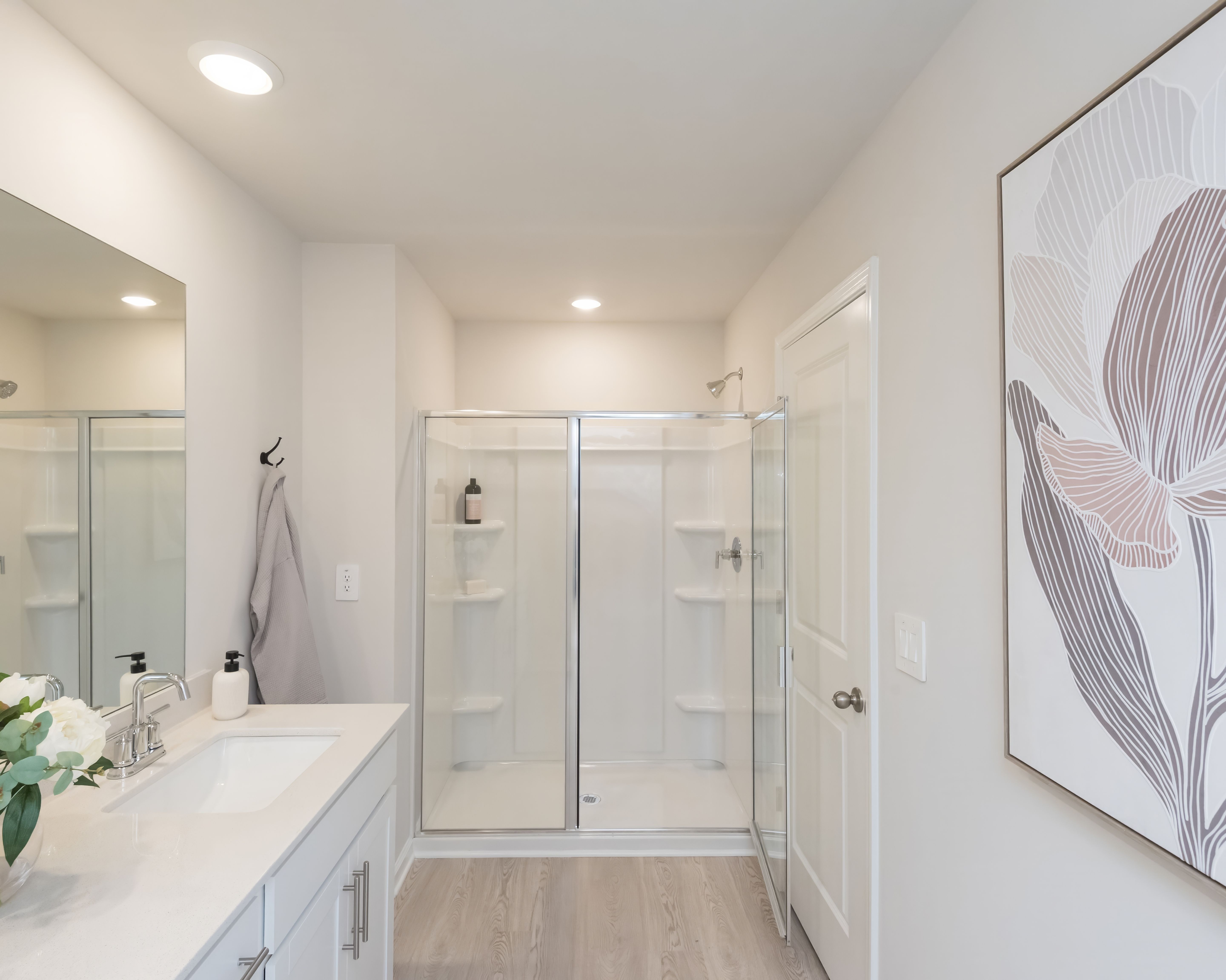 Take a warm shower in the primary bath's walk-in shower, the perfect way to unwind.
