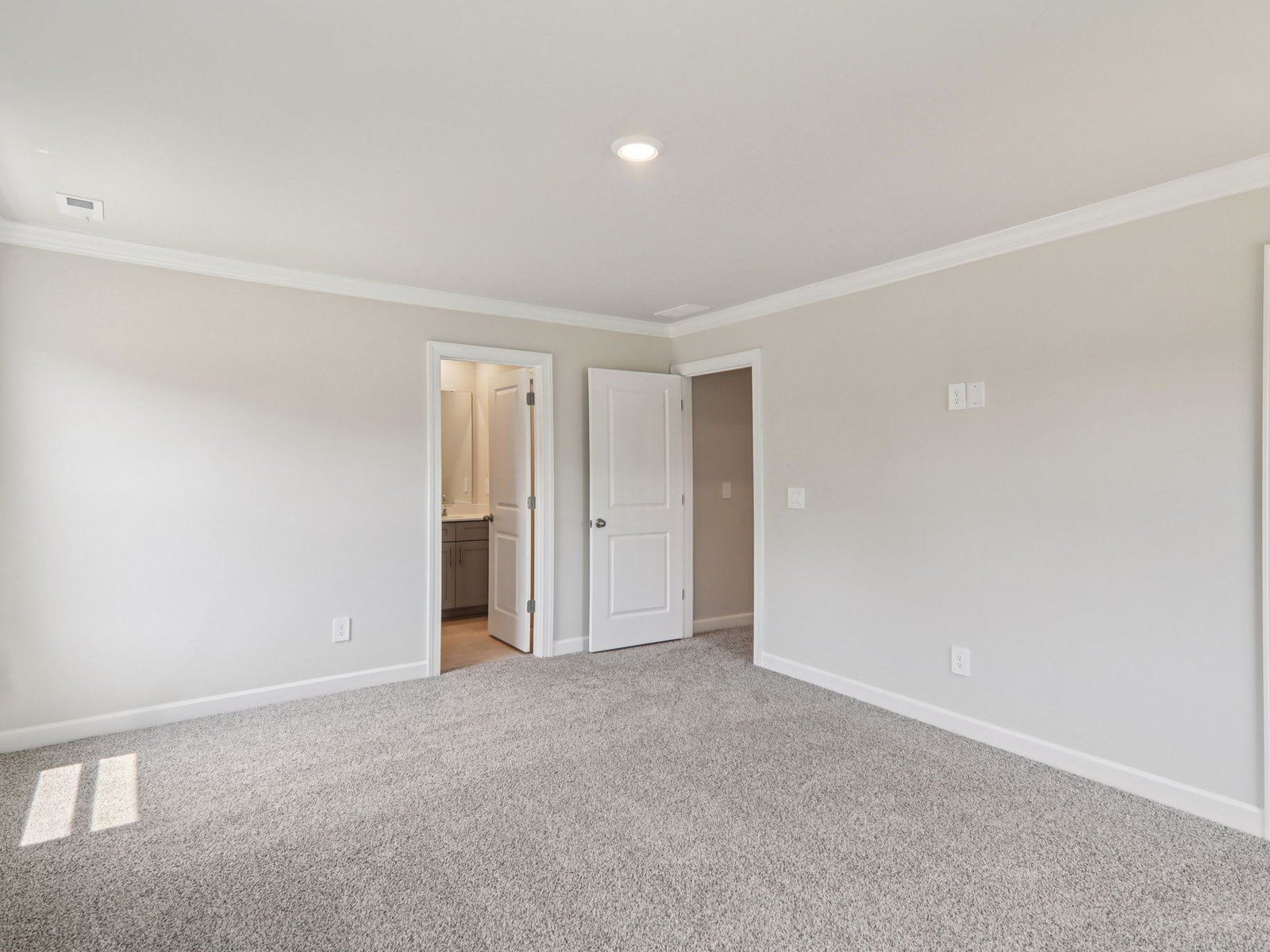 The primary bedroom leads to a private ensuite.