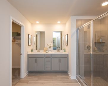 Dual vanities in the primary suite offer style and convenience for two.
