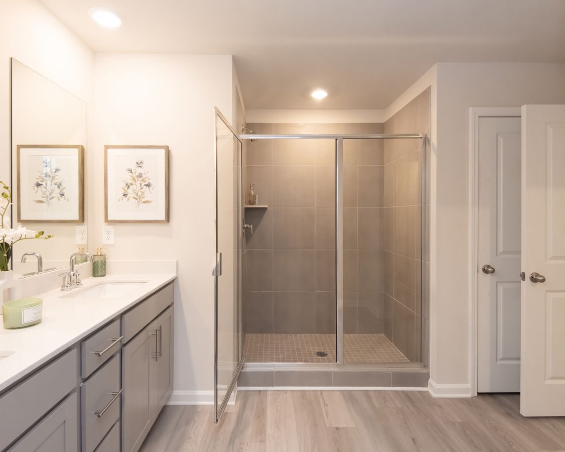 The perfect blend of function and luxury with dual sinks and walk-in shower.