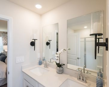 The primary bath features dual-vanity sinks and ample counter space.