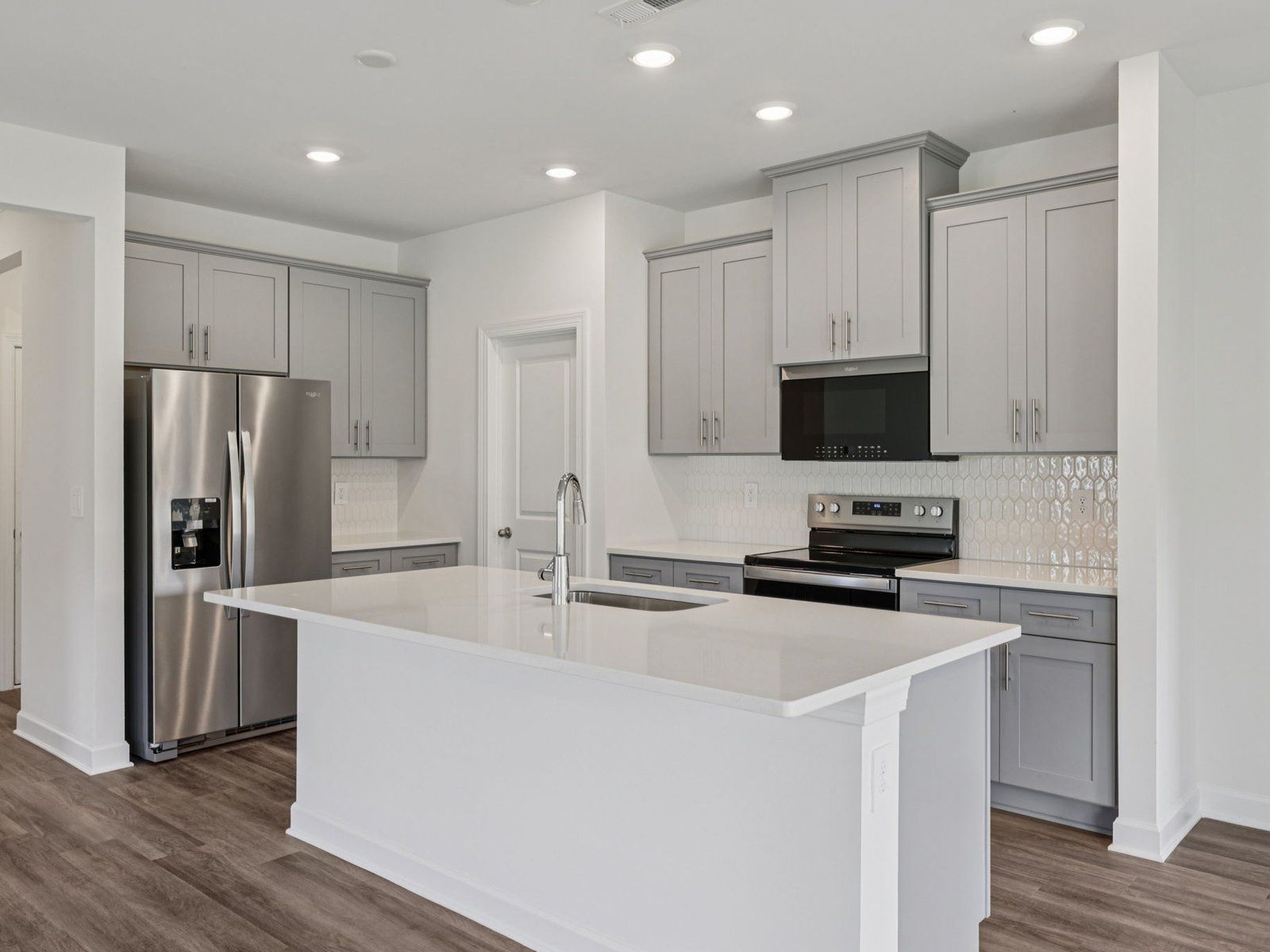 The large kitchen island can be designed as a bar counter for extra seating.