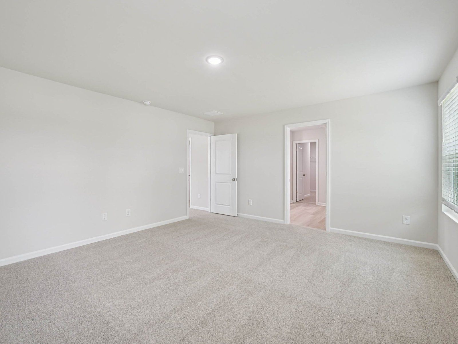 Primary bedroom in the Johnson floorplan at Cadence Meadows in Zebulon, NC.