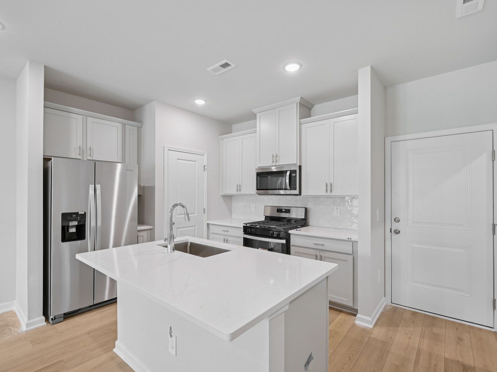 Kitchen in the Bloomfield floorplan at Cadence Meadows Townes in Zebulon, NC.