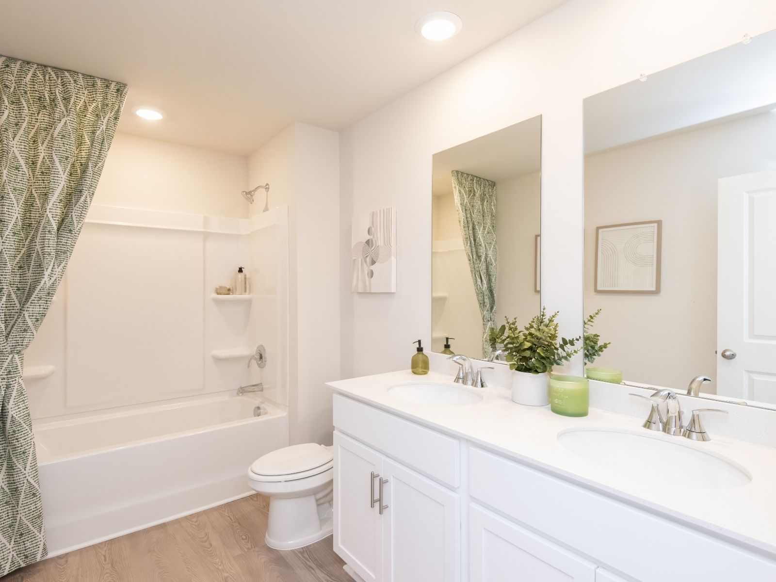 The secondary bedroom features a spacious vanity and oversized shower tub.