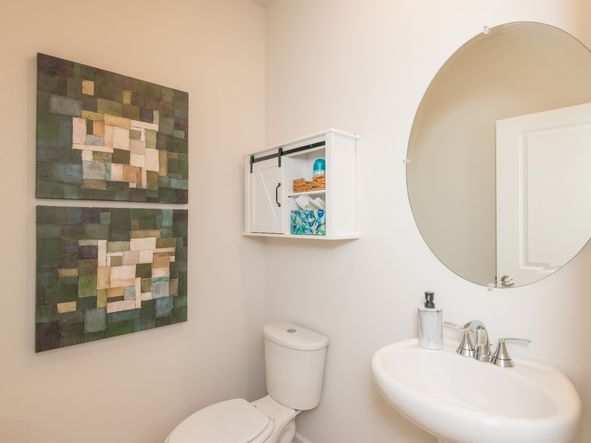 The half bathroom is conveniently located on the first floor for visitors.